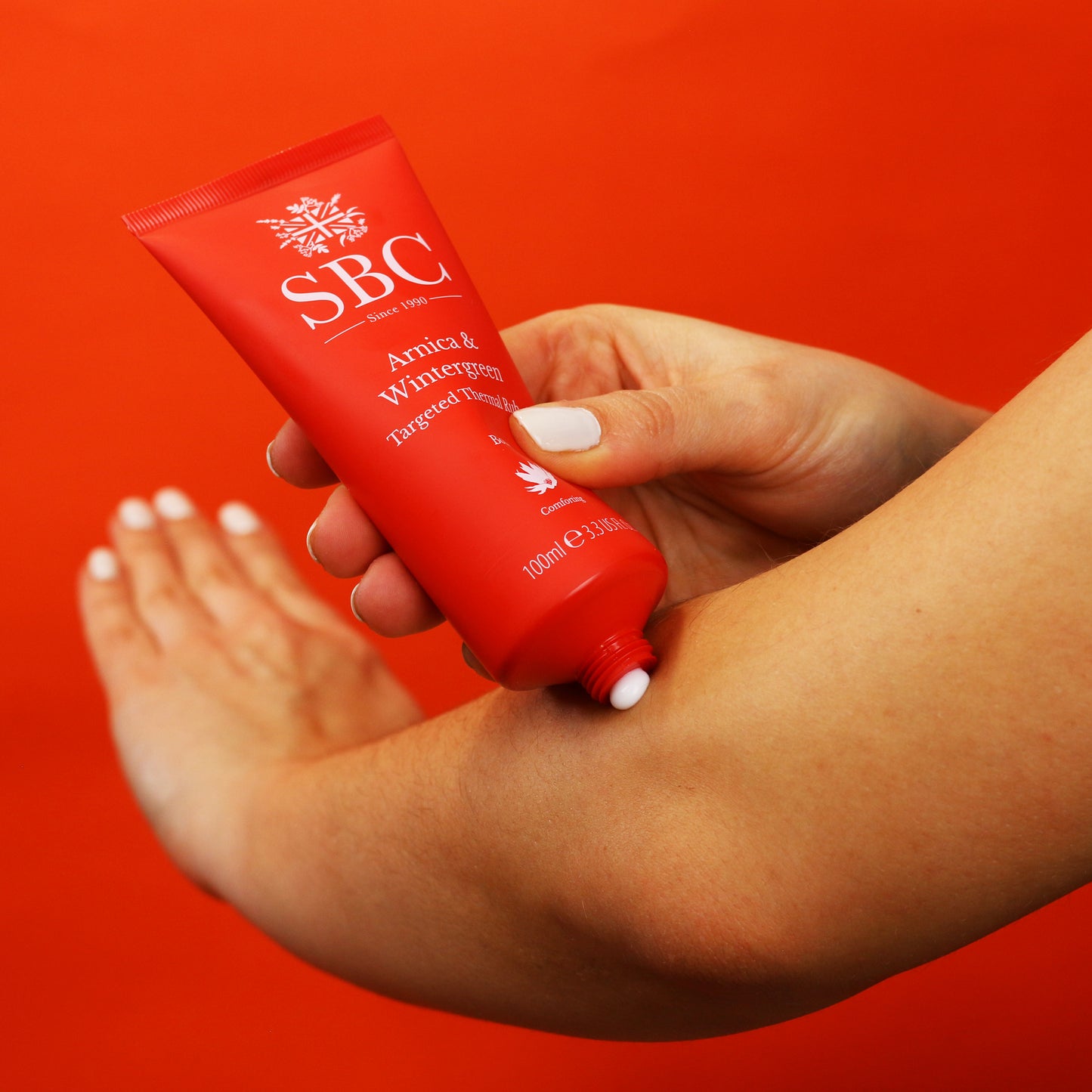 Arnica & Wintergreen Thermal Rub being applied to an arm
