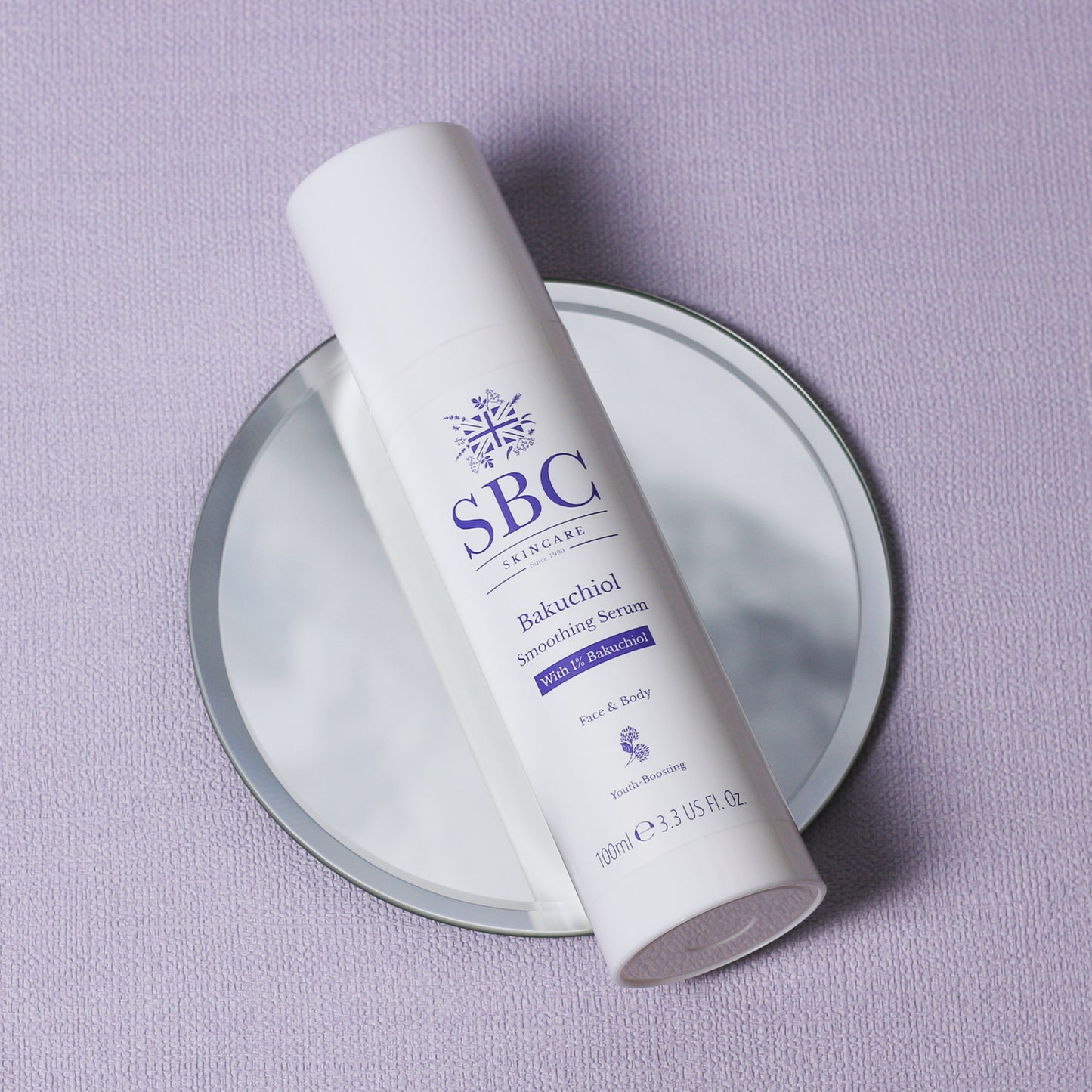 Bakuchiol Smoothing Serum laying on a mirror