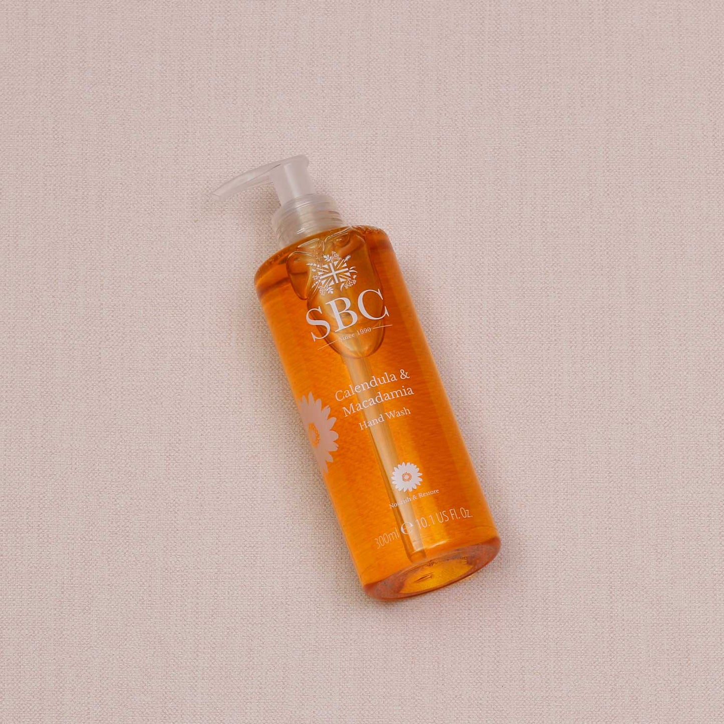 Calendula & Macadamia Hand Wash on a textured beige background