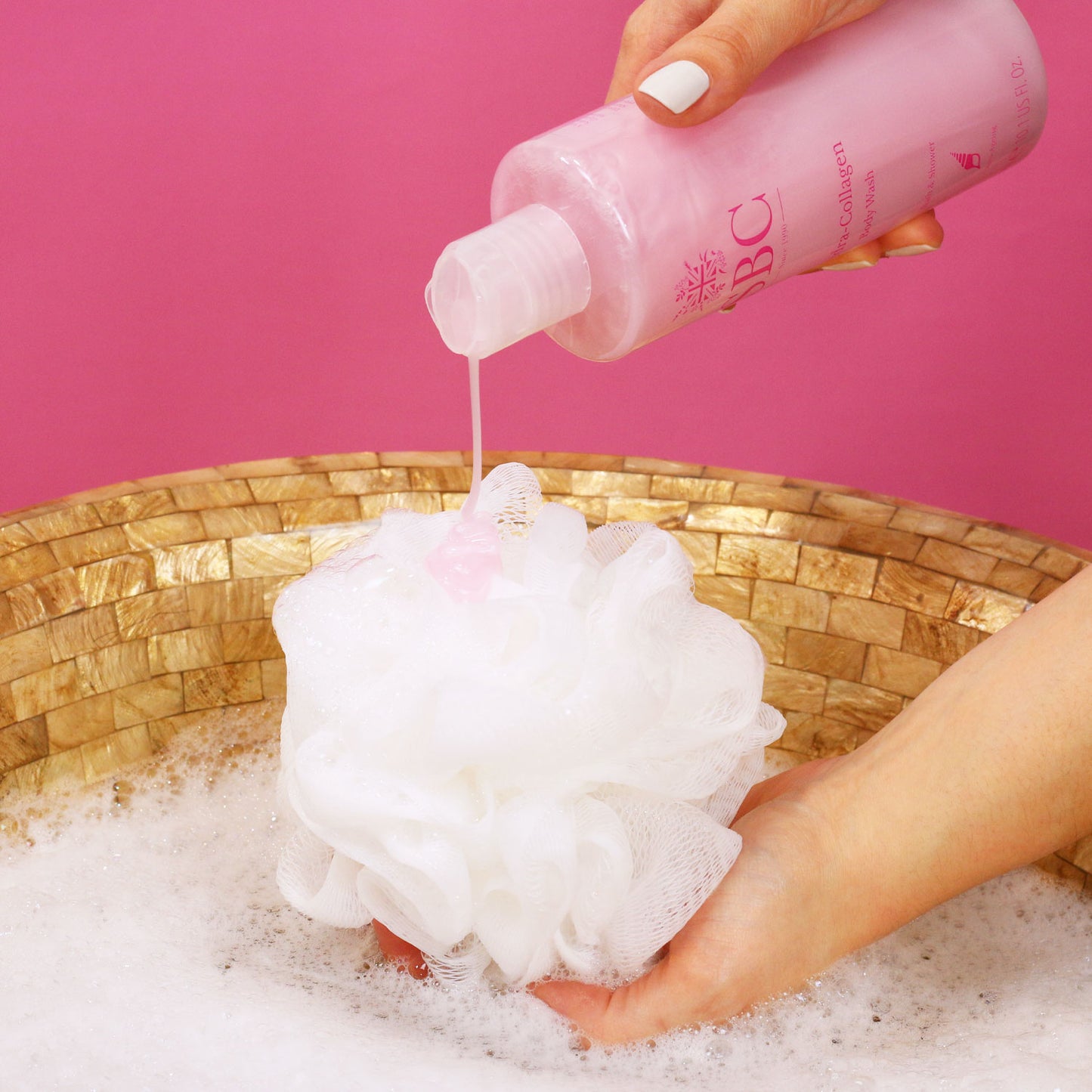 SBC Skincare's Hydra-Collagen Body Wash being poured onto a shower scrunchie