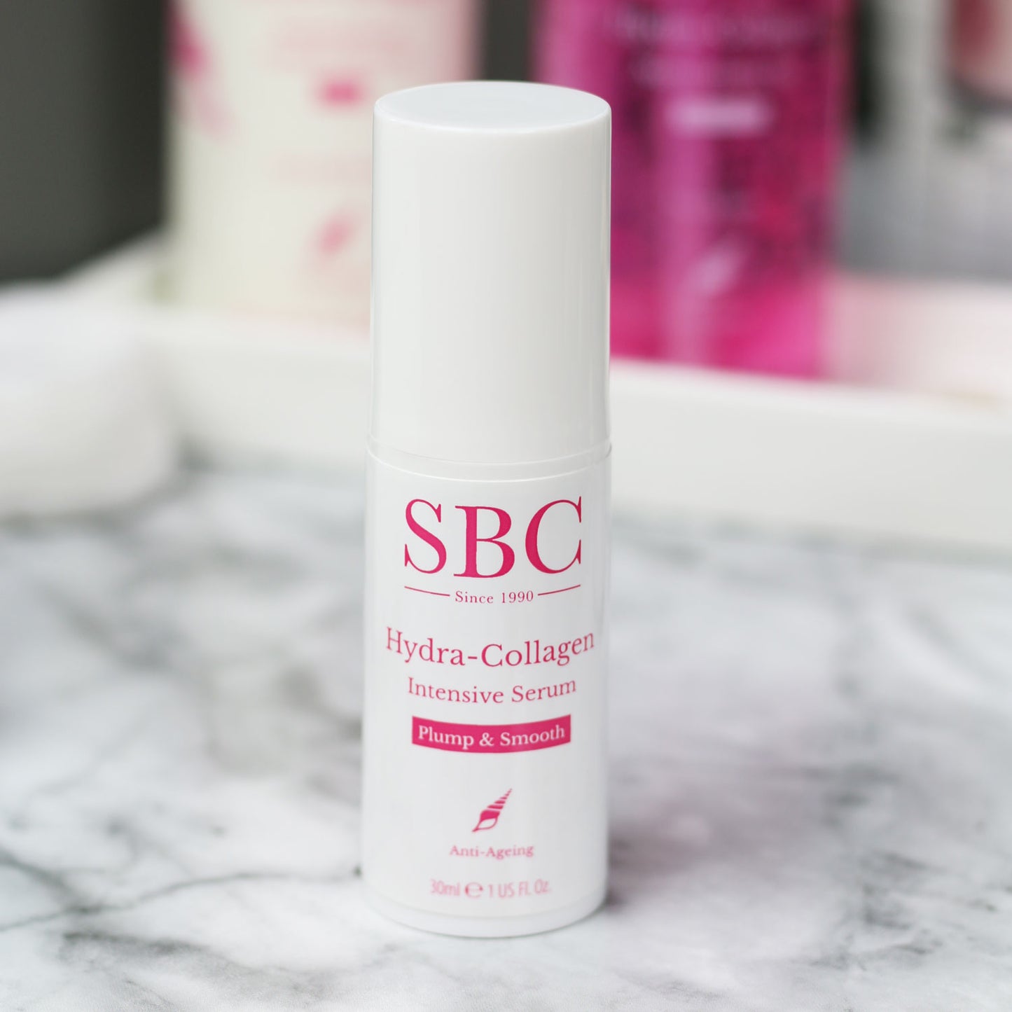 Hydra-Collagen Intensive serum with its cap on on a marble counter