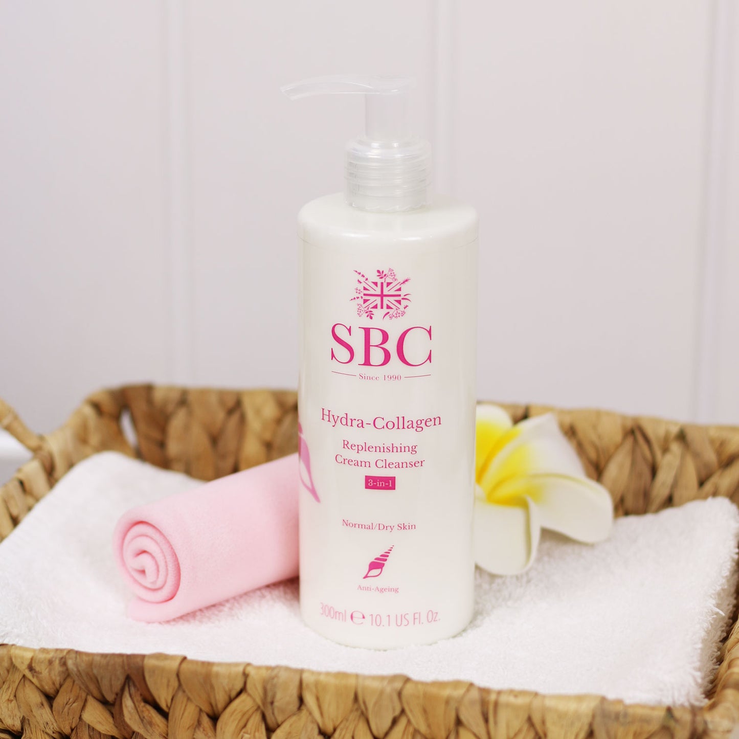 Hydra-Collagen Replenishing Cream Cleanser in a woven basket with a skin shammy