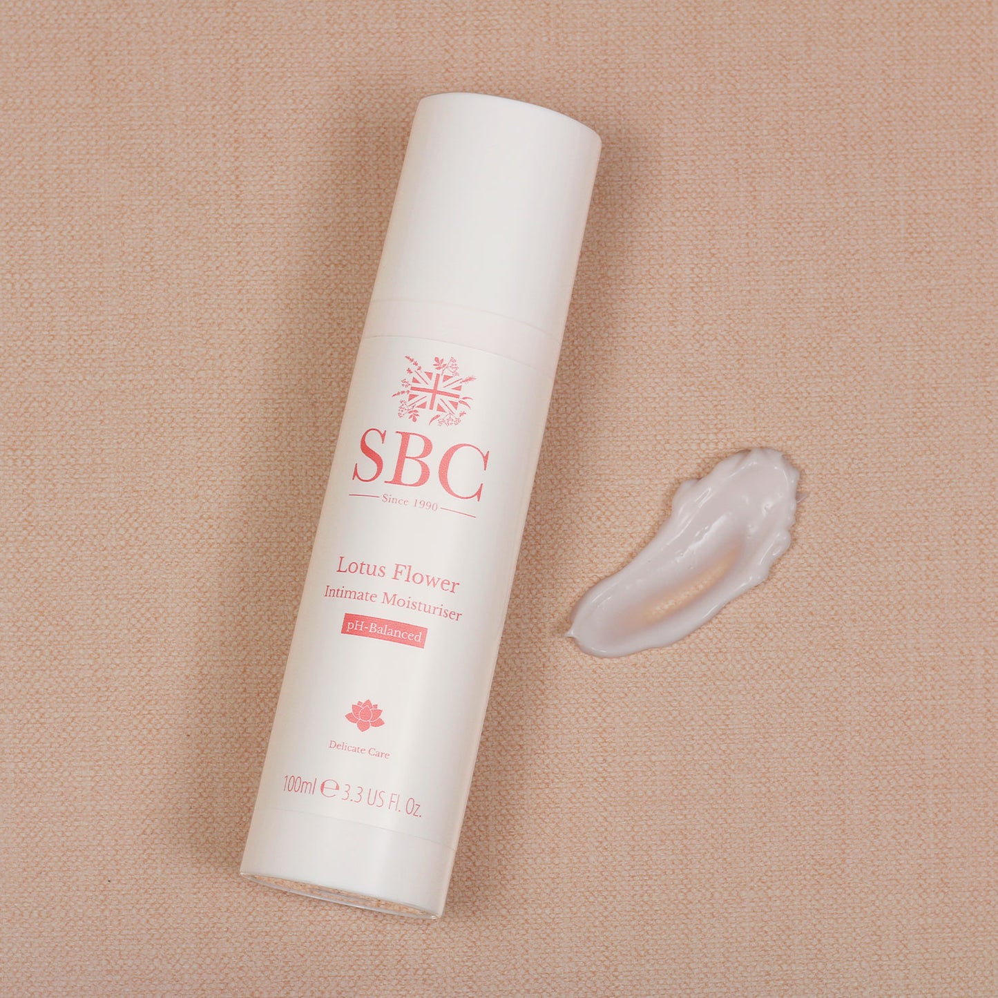 Lotus Flower Intimate Moisturiser on a peach background with a swatch of product