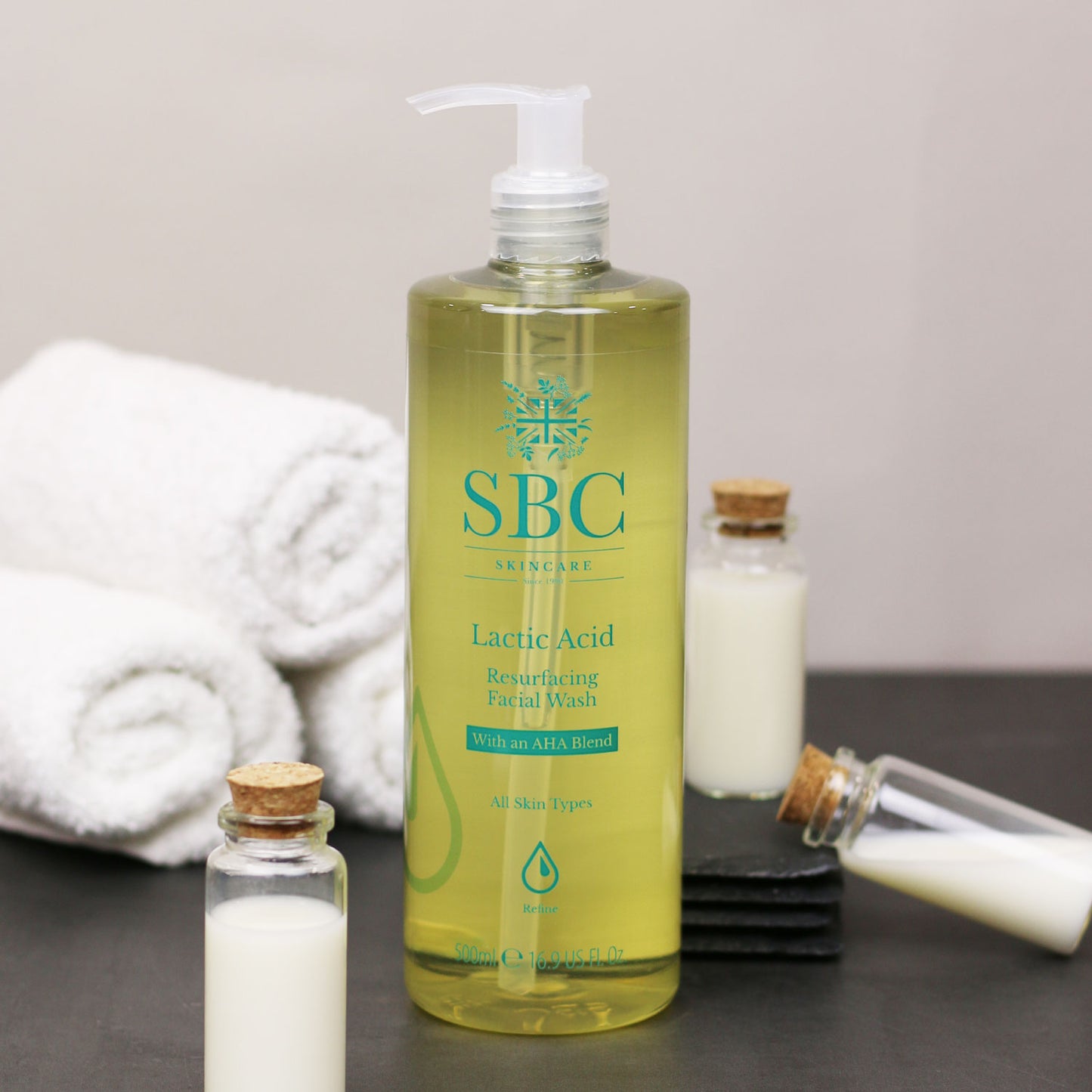 Lactic Acid Resurfacing Facial Wash with glass vials and towels