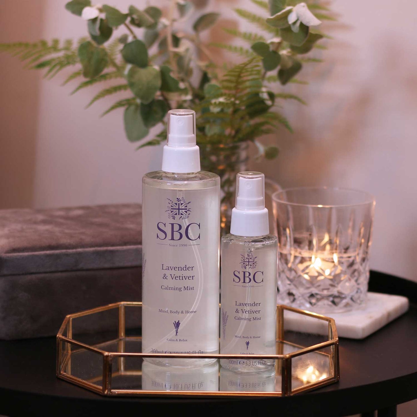 300ml and 100ml Lavender & Vetiver Calming Mist on a bed side table