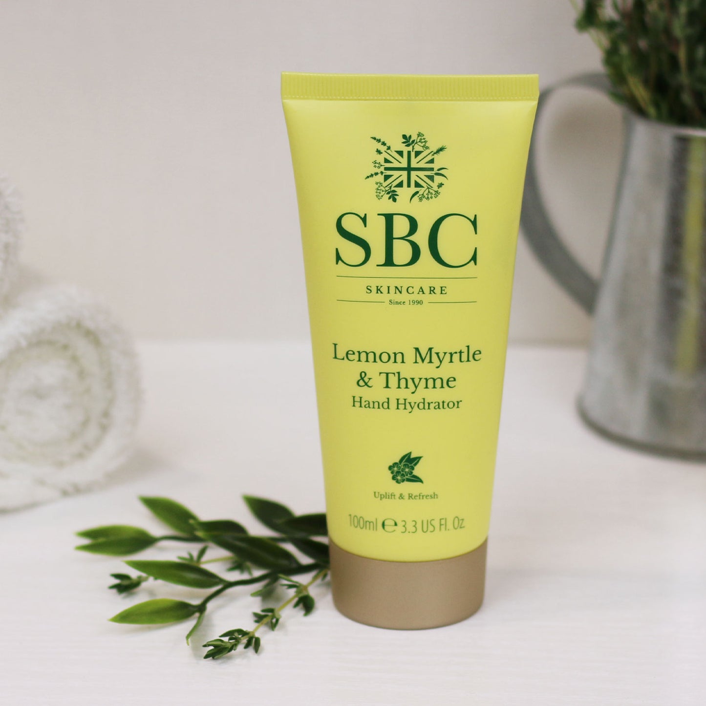 Lemon Myrtle & Thyme Hand Hydrator on a white surface with leaves