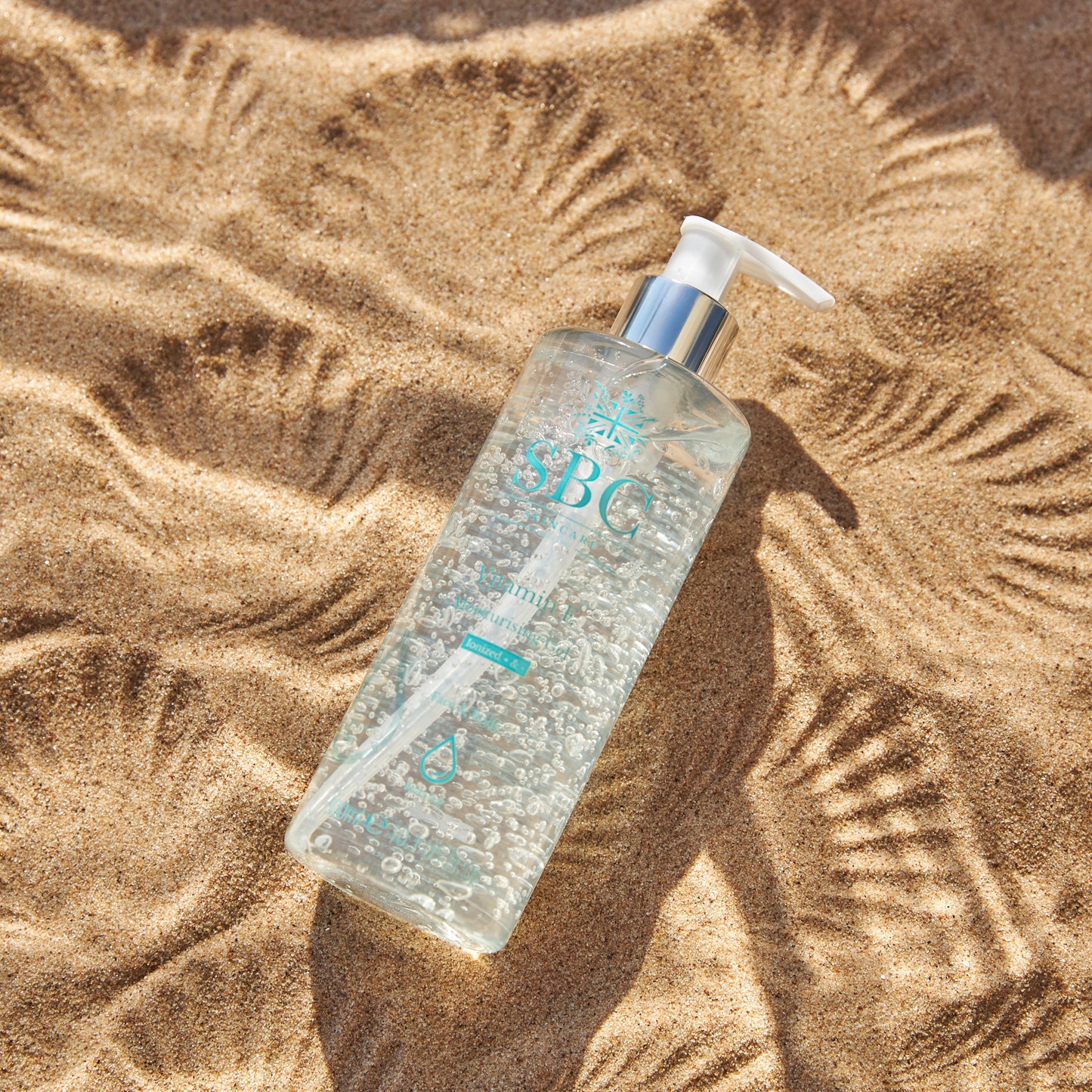 Vitamin E Moisturising Gel on sand with shell imprints