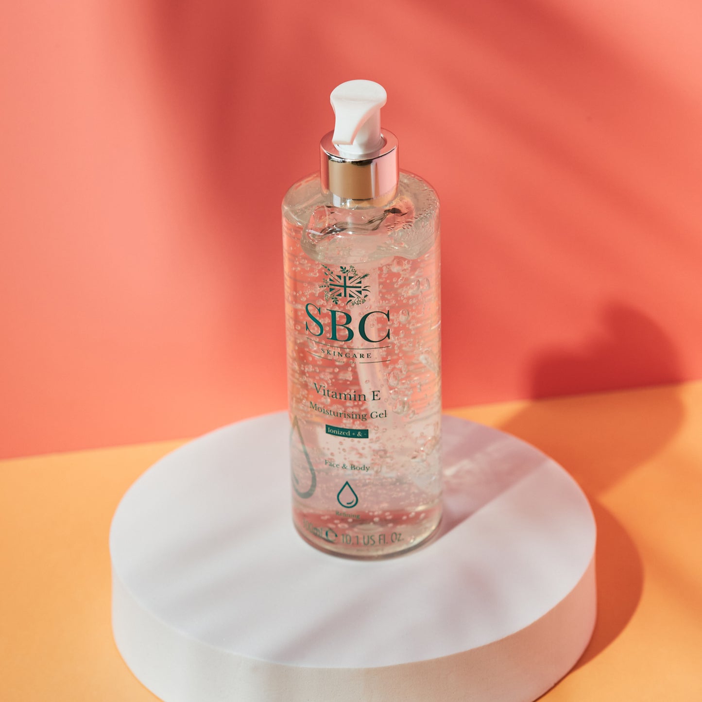 Vitamin E Moisturising Gel on a white plinth with an orange background