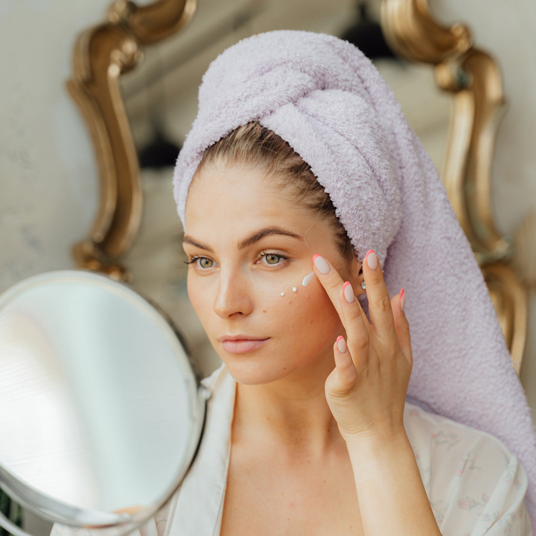 woman applying skincare under eye 