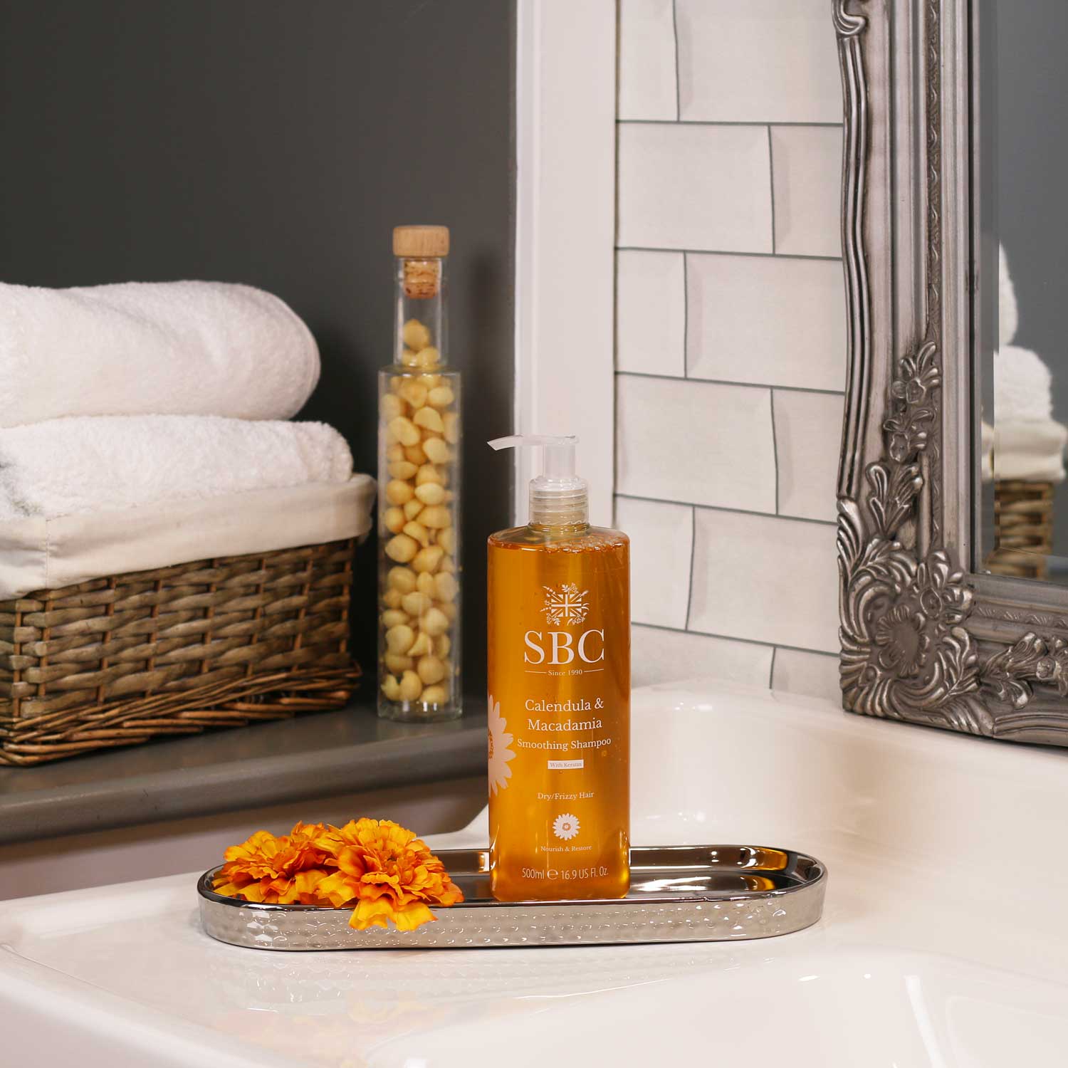 500ml Calendula & Macadamia Smoothing Shampoo in a silver dish on a bathroom sink