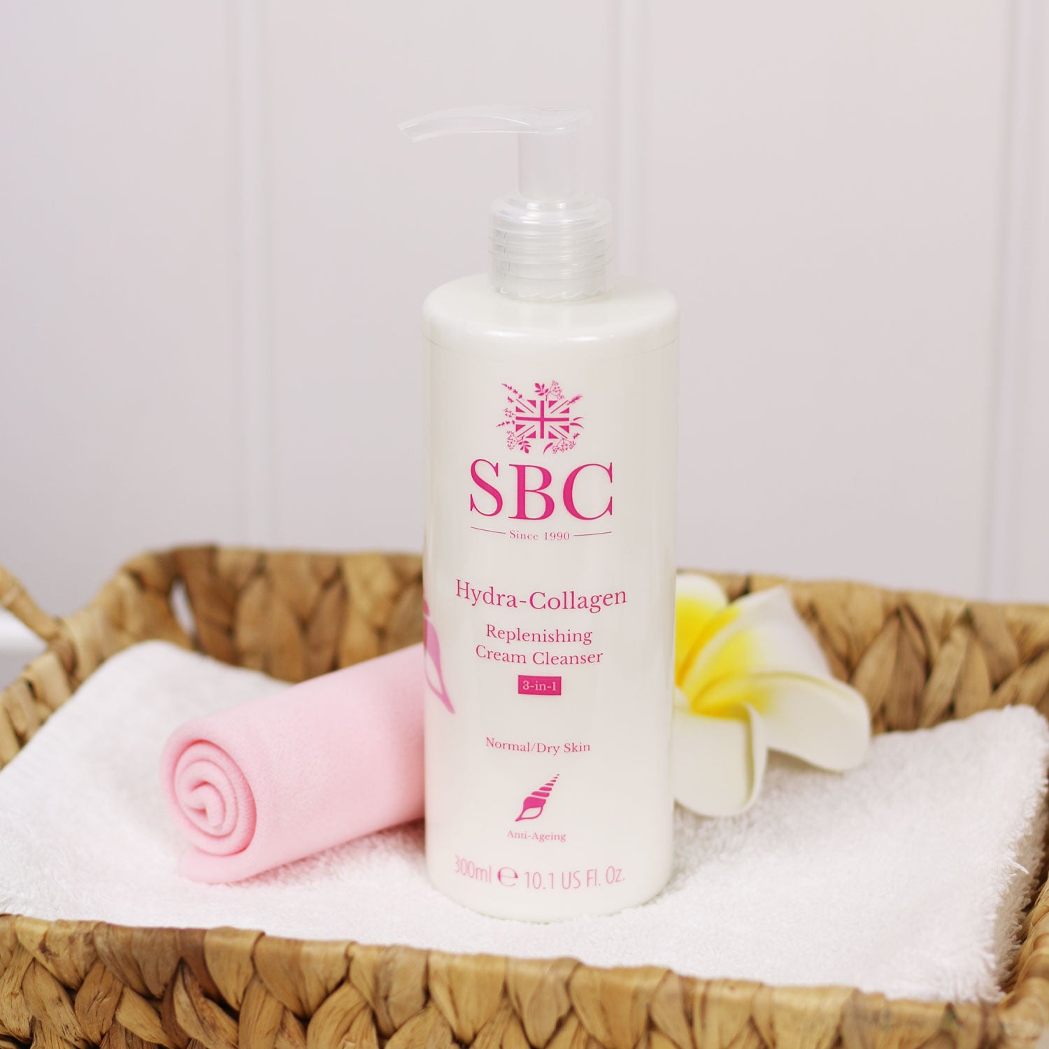 Hydra-Collagen Replenishing Cream Cleanser in a woven basket with a skin shammy 