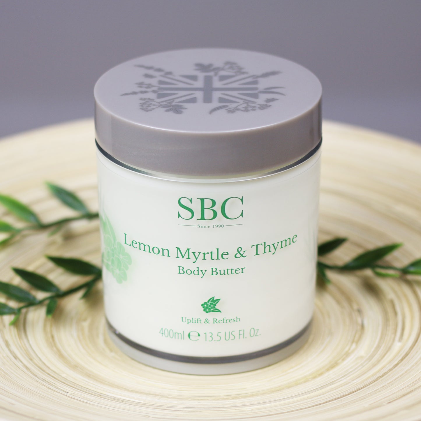 Lemon Myrtle & Thyme Body Butter on a wooden plate