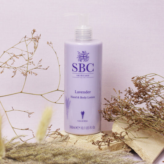 Lavender Hand & Body Lotion surrounded by dried flowers 