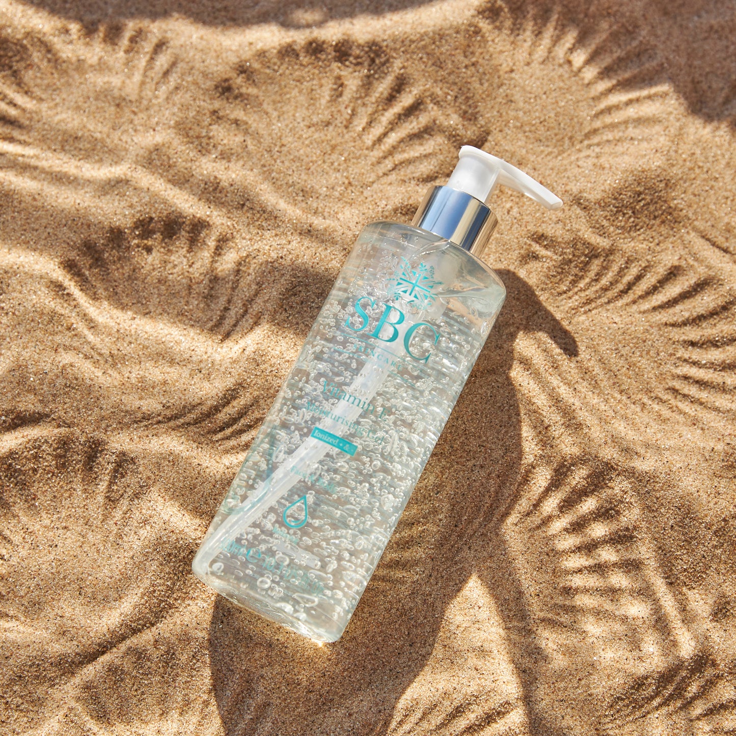 Vitamin E Moisturising Gel on sand with shell imprints 